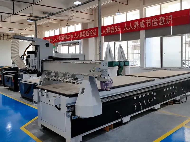 Large CNC cutting machine in a marine flooring manufacturing workshop